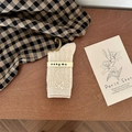 Cream knit mid-calf socks with bow and pearl detailing on vintage wood background - One Size / Khaki