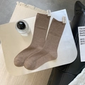 Brown mid-tube knit socks with vertical ribbing and a white decorative fabric label - Coffee