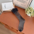 Elegant black fishnet stockings featuring delicate lace trim and mesh ruffle detail - One Size / Black