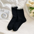 Black crew socks with grey ruffled cuffs and delicate jacquard bow patterns - Black