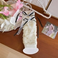 White lace leg warmers with black satin bows and delicate pleats in balletcore style - One Size / Beige