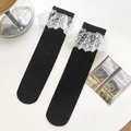 Lolita style black calf socks with vintage white floral lace trim on plain background - One Size / Black