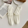 Creamy white ribbed crew socks with elegant silk bow details in a vintage setting - One Size / Creamy White