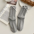 Light gray cotton socks with vertical knit texture and white silk bow accents - One Size / Light Gray