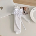 White lace hollow stockings featuring large satin bows and elegant ribbon decorations - One Size / White