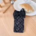 Elegant black lace socks with oversized mesh bow detail on a rustic wood background - Black