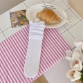 White lace mesh socks with floral embroidery and ruffled trim in a cozy setting - White