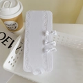 White lace stockings featuring delicate satin bows, elegantly folded in a white basket - One Size / White
