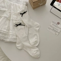 Creamy white openwork knit socks with black bows and frilly edges for women - White