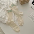 Beige hollow knit crew socks with lettuce trim and a mint green bow detail - Beige