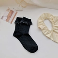 Lolita style black ribbed calf socks with delicate lace trim for women on white background - One Size / Black