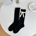Solid black cotton crew socks featuring white silk bows and ruffled lettuce edge trim - Black Base White Bow