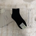 Classic black mid-calf cotton knit sock with ribbed cuff on a plush white background - One Size / Black