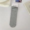 Classic grey cotton crew socks in a slouchy style with a minimalist branded paper card - One Size / Light Gray