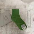 Grass green mid-calf cotton socks with ribbed cuffs on white plush background - One Size / Green