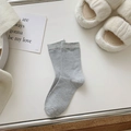 Gray ribbed crew socks with colorful flecked knit pattern on white minimalist background - Light Gray