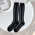 Transparent black knee-high socks featuring stylish wave patterns and sheer mesh texture - Black Grid
