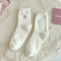 Creamy white plush faux mink socks featuring a cute pink embroidered smiley face - One Size / White