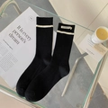 Black ribbed crew socks with white stripes and minimalist fabric label detail - One Size / Black