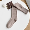 Thick heather beige wool over-knee socks with ribbed cuffs on a white table - One Size / Light Coffee
