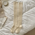 Thick cream white over-the-knee knitted socks with ribbed cuffs in a cozy setting - Milky Yellow