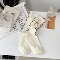 Cream knit mid-calf socks with black ruffle trim and decorative fabric flower - One Size / White