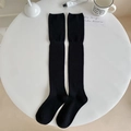 Black over-knee cotton blend socks with vertical ribbed texture on a white table - One Size / Black
