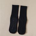 Black non-slip yoga socks with silicone grips on the sole and ribbed mid-calf cuffs - Black