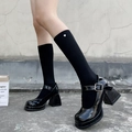 Black Mary Jane platforms with heart detail calf socks on a textured urban background - One Size / Black