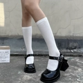 White knee-high mesh knit socks paired with black platform Mary Jane heels for a Lolita look - One Size / White