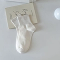 Minimalist solid white cotton low-cut socks with ribbed cuffs on art book backdrop - One Size / White