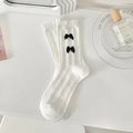 White JK style slouch socks with ruffled edges and black bows in cable knit pattern - One Size / White