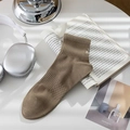 Tan ribbed cotton crew socks with white letter embroidery in a lifestyle setting - One Size / Brown