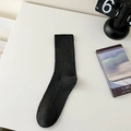 Minimalist men's black crew socks with ribbed texture in a lifestyle desk setting - One Size / Dark Gray