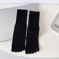 Mid-calf black five-finger cotton socks with ribbed cuffs shown on a white desk - One Size / Black