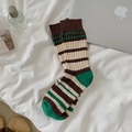 Mid-calf cotton socks with retro green and brown stripes in a cozy home setting - Thin Stripes
