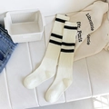 Off-white knee-high socks with two black stripes and vertical ribbed texture - One Size / White with Black Stripes