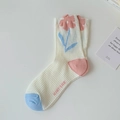 White mesh mid-tube socks featuring pink flower patterns and light blue toe and heel caps - One Size / Single Flower