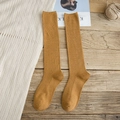 Mustard yellow knee-high socks with vertical ribbed knit on a rustic wood background - One Size / Yellow