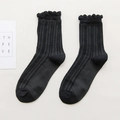 Mid-calf black cotton socks with hollow knit pattern and delicate ruffled lace trim - Black