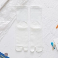White cotton two-toe tabi socks with elastic ribbed cuffs on a textured background - One Size / White