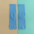 Sky blue cotton tabi socks with ribbed cuff and unique split-toe design in a flat lay view - One Size / Light Blue