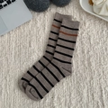 Striped mid-calf socks in beige and black with vibrant orange accents on plush rug - One Size / Medium Coffee with Black Stripes
