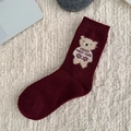 Deep red knitted wool sock featuring a cute cartoon bear with snowflake sweater - One Size / Bear