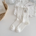 White ruffle cuff mid-calf socks with vintage fabric label and vertical ribbed texture - White