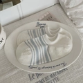 Women's low-cut boat socks in white and light blue stripes on a decorative white plate - One Size / White