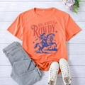 Flat lay of an orange cotton T-shirt with vintage cowboy graphic and denim jeans - Orange