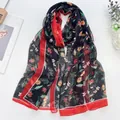 Long summer silk scarf in black with red borders and small daisy floral patterns - Daisy Black
