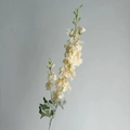Artificial cream delphinium flower spray with soft petals and green foliage for decor - Champagne