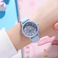 Close-up of sky blue quartz watch worn on wrist with minimalist gray dial and white numbers - Blue